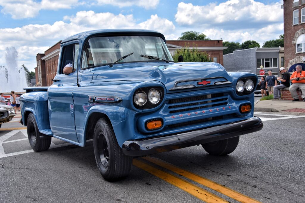 classic blue chevrolet truck driving