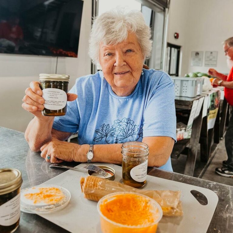 Older woman holding a jar a jelly