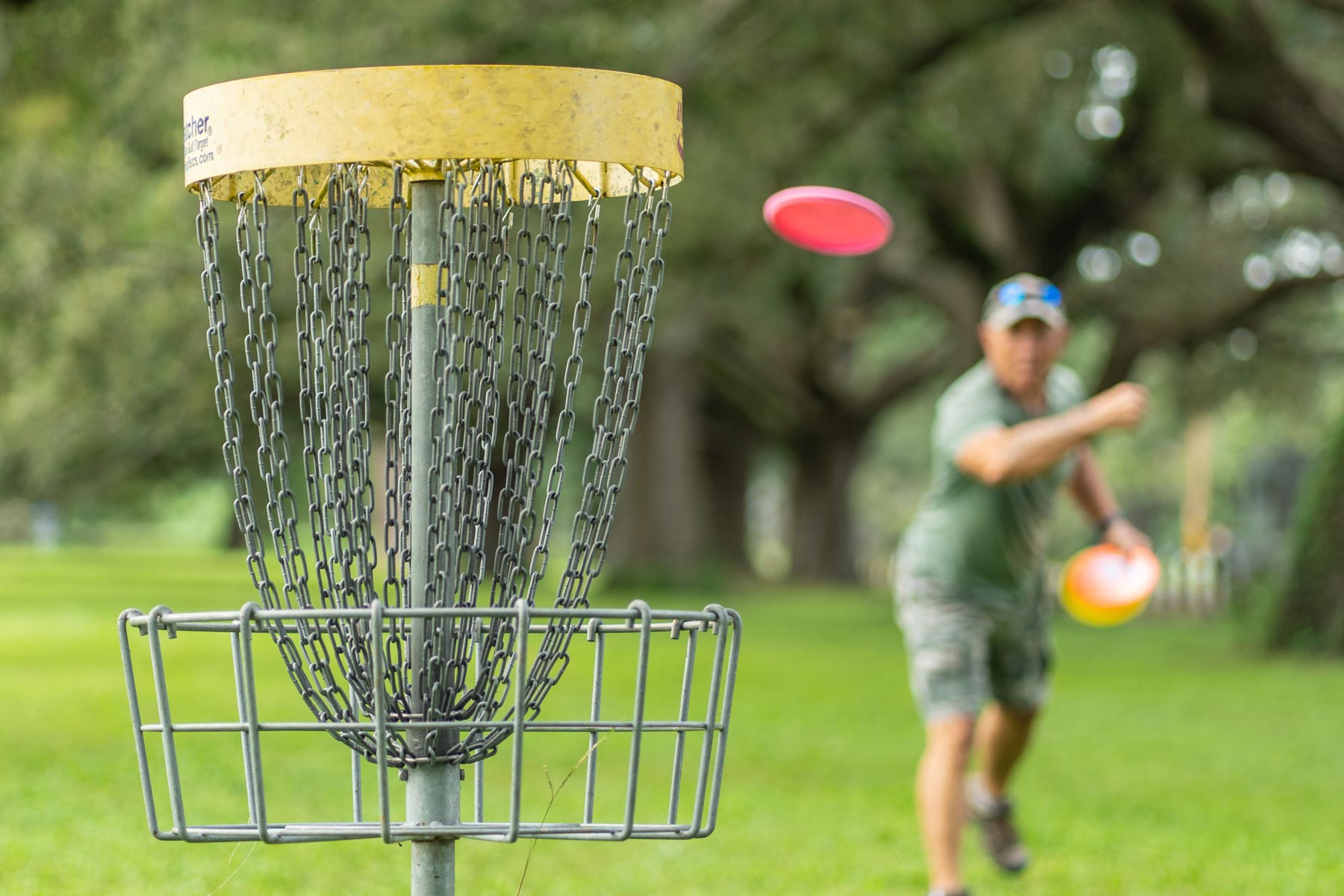 Frisbee golfer throwing towards a basket